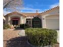 House exterior featuring a two-car garage and neatly landscaped front yard at 3020 Ripon Dr, Las Vegas, NV 89134