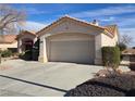 View of the home's exterior, highlighting the two-car garage and landscaping at 3020 Ripon Dr, Las Vegas, NV 89134