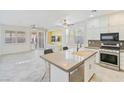 Open concept kitchen island, stainless steel appliances, and a view into the living area at 5372 Polo Grounds St, Las Vegas, NV 89148