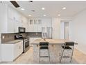 Bright kitchen with white cabinets, granite countertops, and stainless steel appliances at 5372 Polo Grounds St, Las Vegas, NV 89148