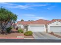 Well-maintained stucco home with tile roof, landscaping, and a two-car garage at 5683 Whale Watch St, Las Vegas, NV 89113