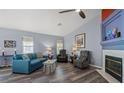 Cozy living room with fireplace and wood-look floors at 5683 Whale Watch St, Las Vegas, NV 89113