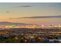 Panoramic city view with twinkling lights from the Las Vegas strip at dusk, visible from the property at 677 Boulder Summit Dr, Henderson, NV 89012