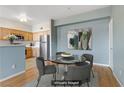 Virtually staged dining area with a glass table and four chairs at 7701 Himalayas Ave # 104, Las Vegas, NV 89128