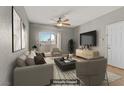 Comfortable living room features a ceiling fan, TV, and sliding glass door to a balcony at 7701 Himalayas Ave # 104, Las Vegas, NV 89128