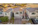 Aerial view of house with solar panels and driveway at 23 Papavero Ct, Henderson, NV 89011