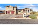 Two-story home featuring desert landscaping, a mailbox, and a paved driveway at 260 E Desert Rose Dr, Henderson, NV 89015