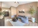 Living room with sectional sofa, coffee table, and views to hallway at 6316 W Gowan Rd, Las Vegas, NV 89108