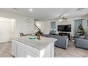 Open-concept living room with view of the kitchen and staircase at 361 Andy Wheeler Dr, Henderson, NV 89011