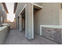 Side entrance with stone-faced wall and post. Brick-paved walk-way at 361 Andy Wheeler Dr, Henderson, NV 89011