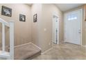 Inviting foyer featuring tile flooring, staircase, and front door at 5372 Silver Branch Ave, Las Vegas, NV 89118