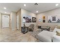 Open-concept living room boasts tile flooring, neutral tones, and stylish decor at 5372 Silver Branch Ave, Las Vegas, NV 89118