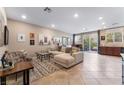 Spacious living room featuring a large sectional sofa and sliding door to the patio at 5372 Silver Branch Ave, Las Vegas, NV 89118