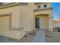 Front entrance with dark-colored door and walkway at 6547 Velvet Silk St, North Las Vegas, NV 89084