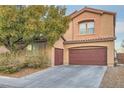 Two-story home featuring a two-car garage, desert landscaping, and a charming facade at 6616 Sea Swallow St, North Las Vegas, NV 89084