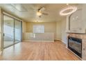 Living room with hardwood floors, fireplace and access to balcony at 7151 S Durango Dr # 214, Las Vegas, NV 89113