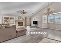 Spacious living area with fireplace, vaulted ceiling, and L-shaped sofa at 1550 Desertaire Way, Las Vegas, NV 89110