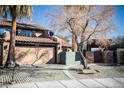 Tan two-story house with a courtyard and gated entry at 2205 Alia Ct, Las Vegas, NV 89102