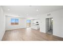 Bright and airy living room featuring wood-look floors, large windows, and an open layout at 633 N Water St, Henderson, NV 89015