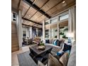 Bright living room with comfy seating, large windows, and open floor plan at 655 Agate Bridge St, Las Vegas, NV 89138