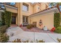 Front entry with ornate double doors, fountain, and brick patio at 8736 Double Eagle Dr, Las Vegas, NV 89117