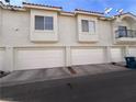 Townhouse exterior featuring multiple garages, clean architecture, and tidy landscaping at 6201 E Lake Mead Blvd # 216, Las Vegas, NV 89156