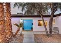 Welcoming front entry with a bright blue door at 2240 Mohigan Way, Las Vegas, NV 89169