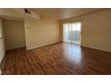 Living room with sliding doors to balcony and wood-look floors at 2606 S Durango Dr # 172, Las Vegas, NV 89117