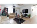 Bright living room featuring hardwood floors and a large TV at 2817 Mardi Gras Ln, North Las Vegas, NV 89030