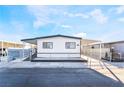 Front view of a remodeled manufactured home with a carport and fenced yard at 3490 Allegheny Dr, Las Vegas, NV 89122