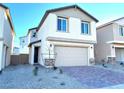 Two-story house with neutral color scheme and a two-car garage at 4763 Illustria Ave, Las Vegas, NV 89141