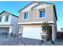 Two-story house with white garage door, light beige exterior, and landscaping at 4771 Illustria Ave, Las Vegas, NV 89141