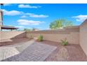 A cozy backyard with a beautiful stone patio surrounded by low-maintenance gravel landscaping and block wall at 4529 Swimming Minnow Ave, Las Vegas, NV 89141