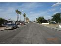 Street view of the property with palm trees and parked cars on a sunny day at 4709 W Alpine Pl, Las Vegas, NV 89107