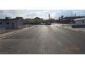 Street view of the property with a wide street and commercial buildings in the background at 4709 W Alpine Pl, Las Vegas, NV 89107