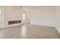Spacious living room with a modern fireplace and ample space for entertaining at 104 Barkset Way, Henderson, NV 89011