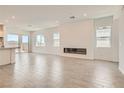 Bright living room with a modern fireplace, and large sliding doors for ample natural light at 104 Barkset Way, Henderson, NV 89011
