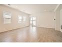 Bright living room featuring wood-look tile floors, recessed lighting and access to the backyard at 106 Barkset Way, Henderson, NV 89011
