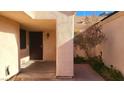 Covered side entrance with a dark brown door and small courtyard at 1940 Whiton St, Las Vegas, NV 89156