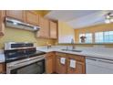 A bright kitchen with stainless steel appliances, light wood cabinets and white countertops at 2020 Rancho Lake Drive Dr # 205, Las Vegas, NV 89108