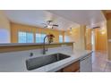 Bright kitchen features a stainless steel sink, modern faucet, and white countertops overlooking the living space at 2020 Rancho Lake Drive Dr # 205, Las Vegas, NV 89108