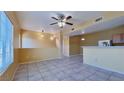 Spacious living room featuring tile floors, a ceiling fan, and access to the kitchen at 2020 Rancho Lake Drive Dr # 205, Las Vegas, NV 89108