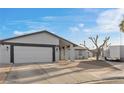 House exterior with two-car garage and landscaping at 4767 Del Sueno Dr, Las Vegas, NV 89120