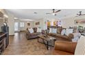 Open living area with tile floors and brown sofas at 4767 Del Sueno Dr, Las Vegas, NV 89120