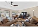 Spacious living room with leather sofas and large TV at 4767 Del Sueno Dr, Las Vegas, NV 89120