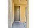 Brown front door entry with covered porch at 5455 Hasley Canyon Ave, Las Vegas, NV 89139