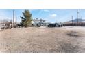 House with a large yard and desert landscape in the background at 664 Spring Rd, Indian Springs, NV 89018