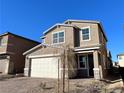 Two-story house with neutral exterior, attached garage, and landscaped front yard at 9922 Angel Valley Dr, Las Vegas, NV 89178