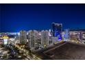 Elevated view of the Las Vegas cityscape at night featuring illuminated buildings and bustling streets at 222 Karen Ave # 3907, Las Vegas, NV 89109