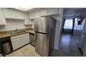 Stainless steel refrigerator and dishwasher in a kitchen with granite countertops at 6311 W Washington Ave, Las Vegas, NV 89107